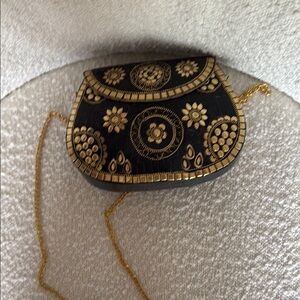 Luxurious Black and Gold Crossbody Bag with Ornate Detailing
